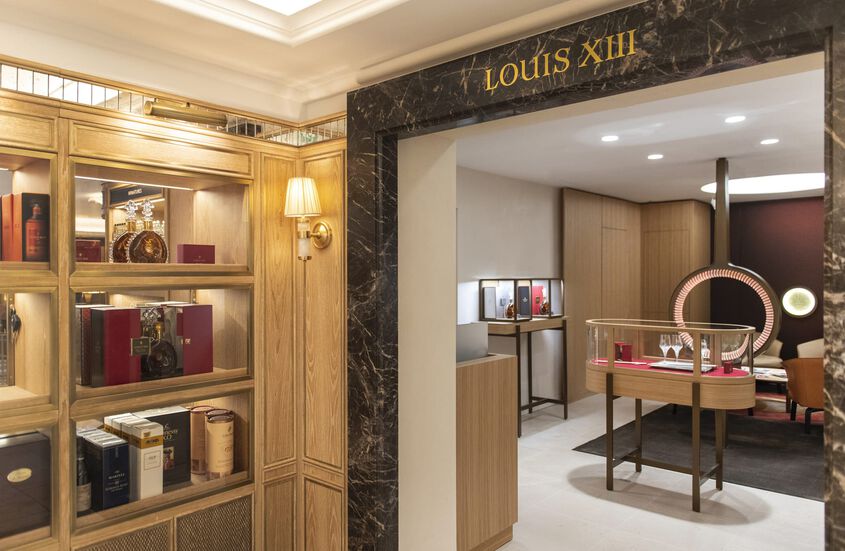 A photo of the Harrods boutique with LOUIS XIII decanters on the display