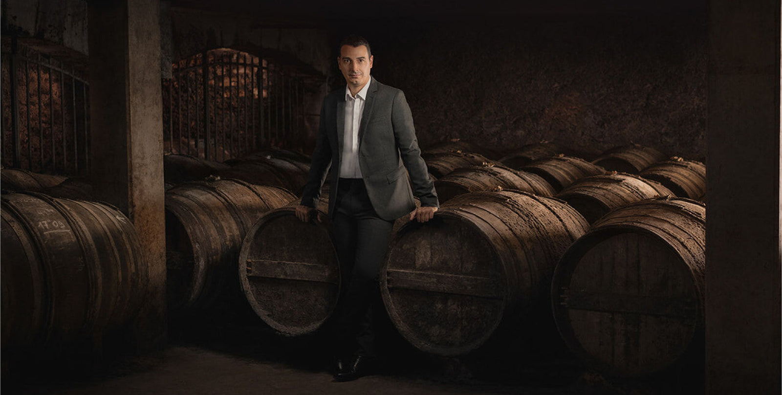 A photo of Baptiste Loiseau posing among barrels