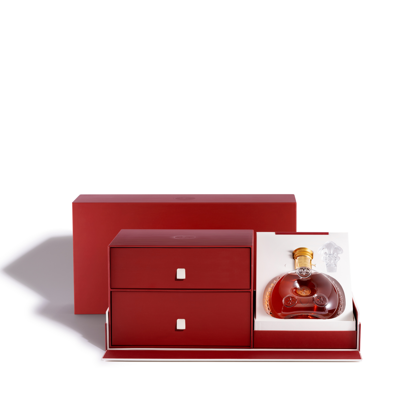 A packshot of a red cigar set packaginf with the decanter exposed, white background