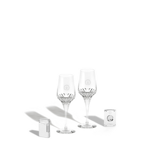 A packshot of two LOUIS XIII crystal glasses with cigar accessories, white background