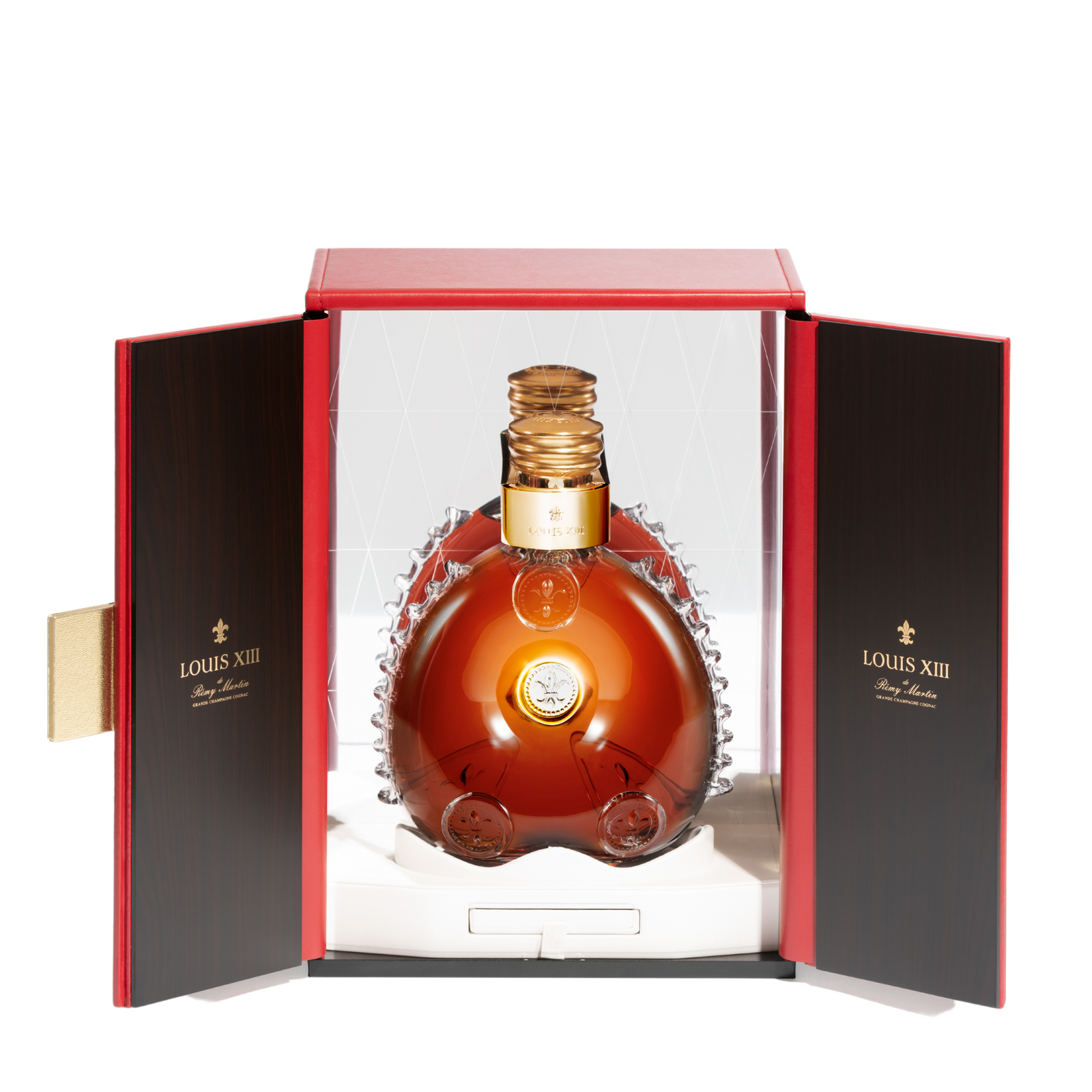 A packshot of LOUIS XIII decanter in a red open packaging, white background