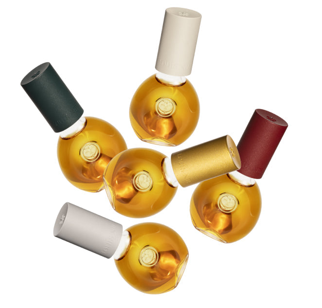 A packshot of five DROP bottles in different colors on a white background